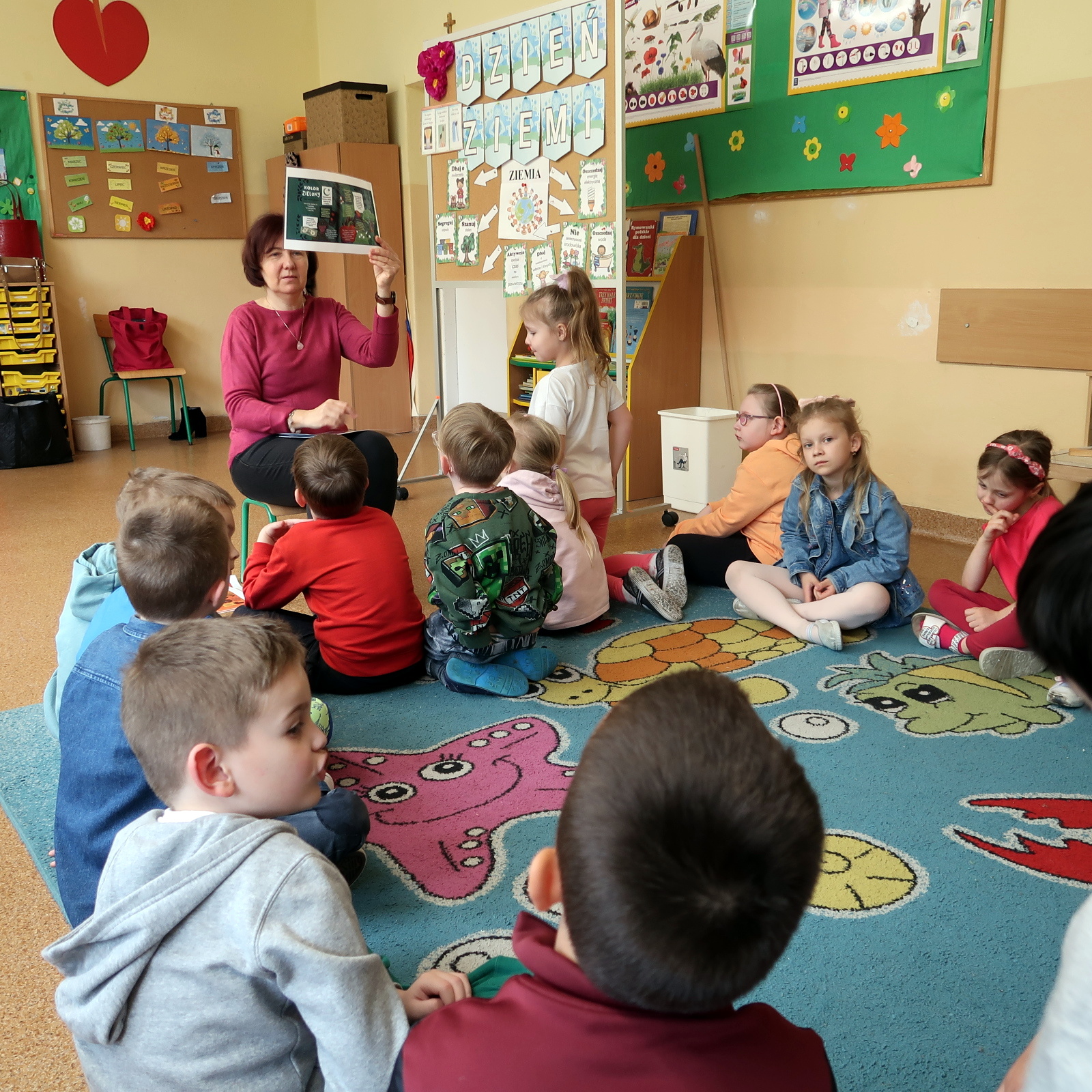 Nauczycielka pokazuje dzieciom ilustrację